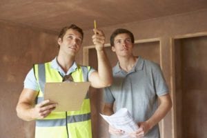 Roofing Contractor Explaining Roofing Inspection and Estimate to Homeowner