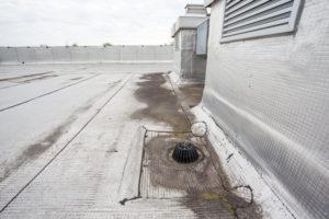 flat roof drain needs repair commecial roof replacement