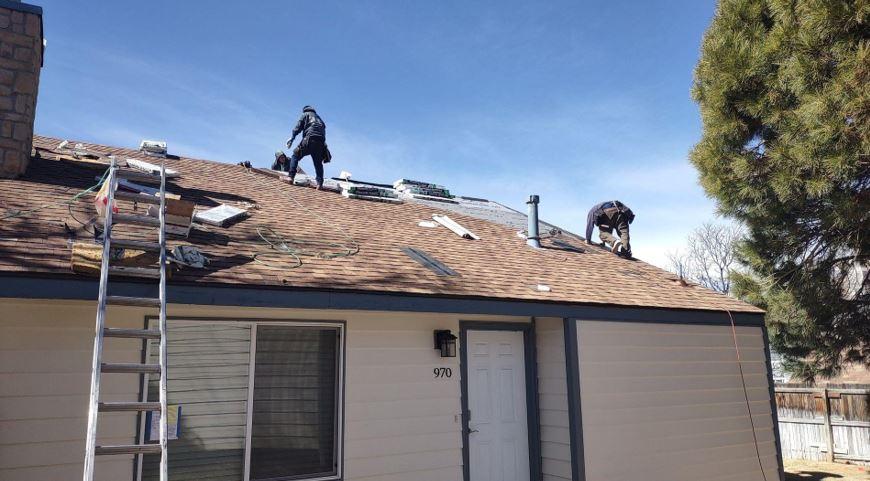 Roofers reparing roof in Littleton